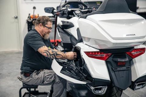 A guy fixing a motorbike